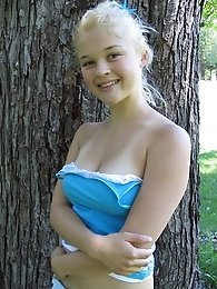 Pretty blonde teen girl Christine Young posing in a park