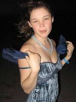 cheerful teen christine young poses after dark on the beach