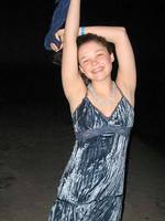 cheerful teen christine young poses after dark on the beach